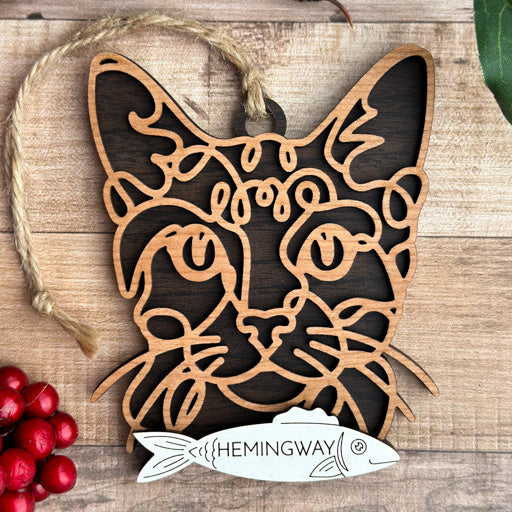 Ocicat line art cat ornament laser cut from natural wood, minimalist feline silhouette design