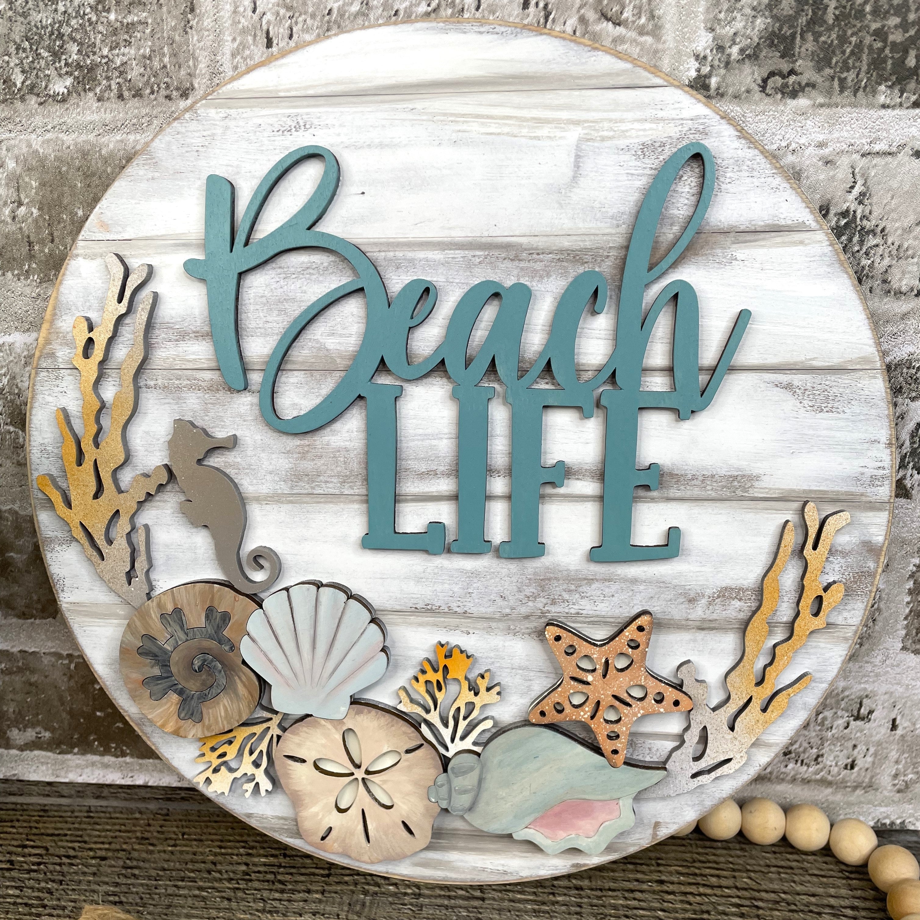 Beach Life Door Hanger with sea shells, coral and sea creatures on a shiplap backer