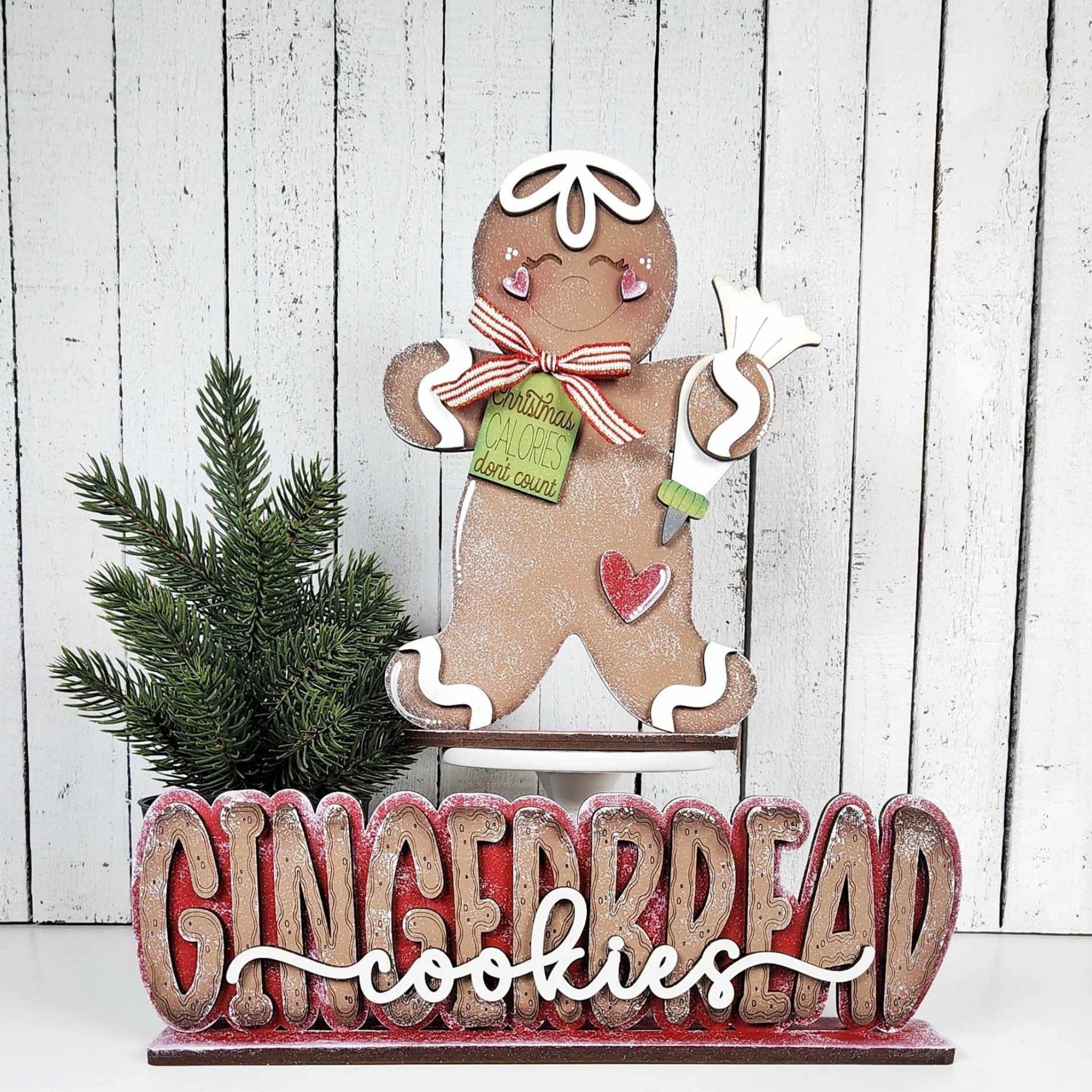 Decorative gingerbread man with 'GINGERBREAD cookies' text on a wooden background