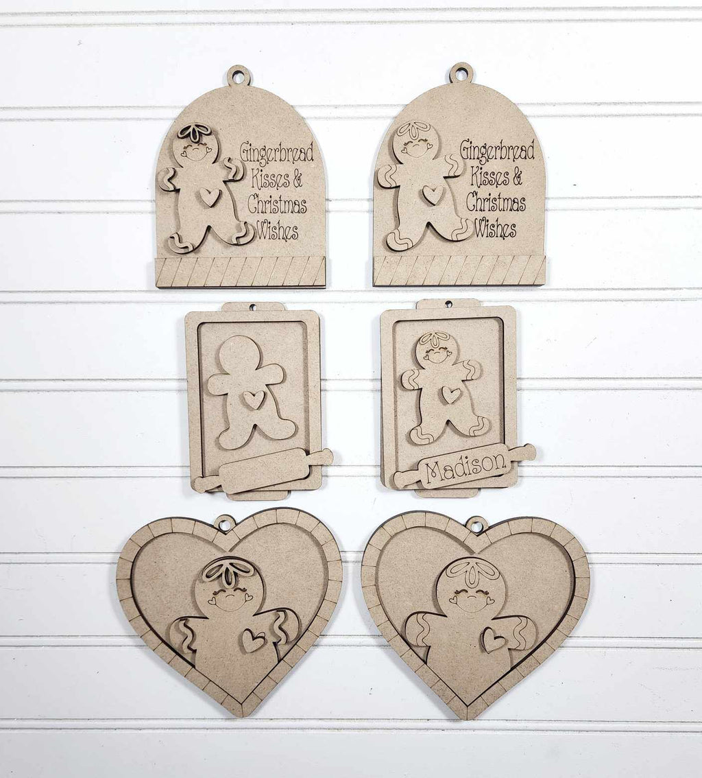 Set of wooden ornaments with gingerbread man designs on a white background