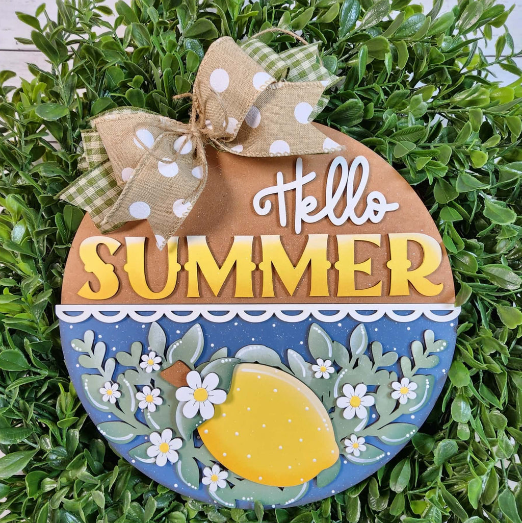 Decorative sign with 'Hello Summer' text and lemon design on a green leaf background