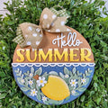 Decorative sign with 'Hello Summer' text and lemon design on a green leaf background