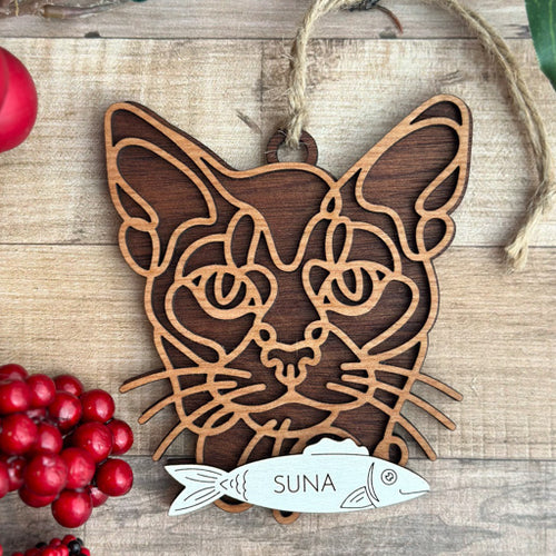 Abyssininian line art cat ornament laser cut from natural wood, minimalist feline silhouette design