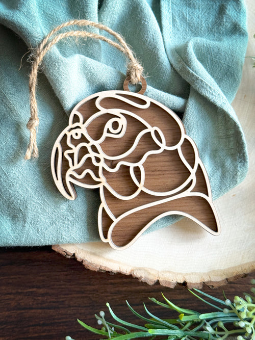 African grey parrot line art ornament laser cut from natural wood in continuous line style