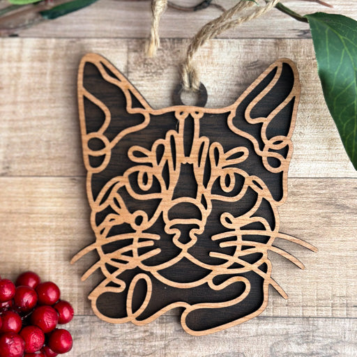 Bengal line art cat ornament laser cut from natural wood, minimalist feline silhouette design