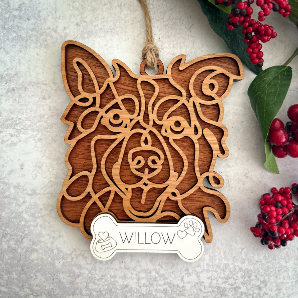 Border Collie line art dog ornament laser cut from natural wood.
