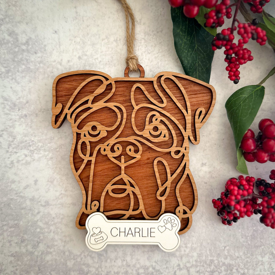 Boxer line art dog ornament laser cut from natural wood.