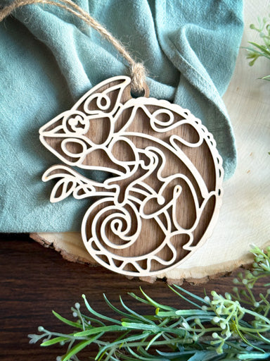 chameleon line art ornament laser cut from natural wood in continuous line style