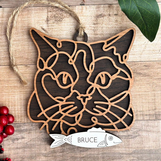 Chartreux line art cat ornament laser cut from natural wood, minimalist feline silhouette design