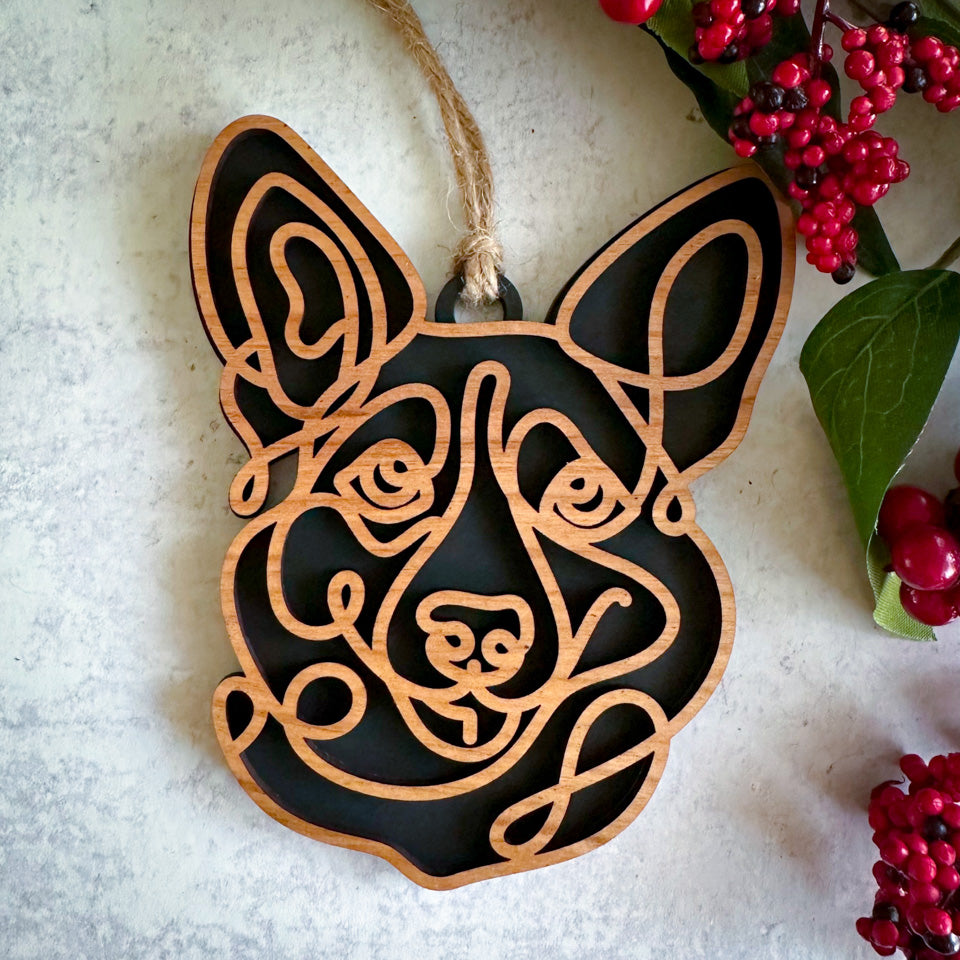 Corgi line art dog ornament laser cut from natural wood.