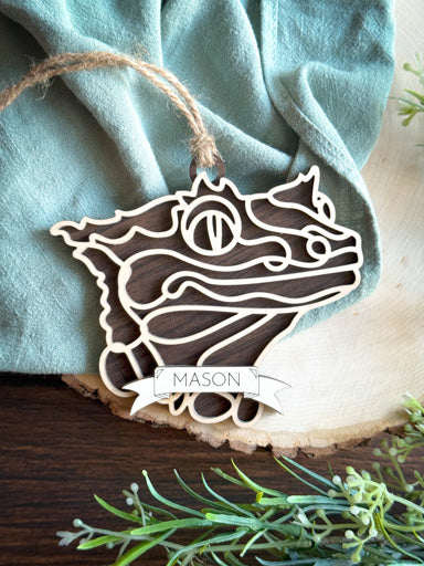 crested gecko line art ornament laser cut from natural wood in continuous line style