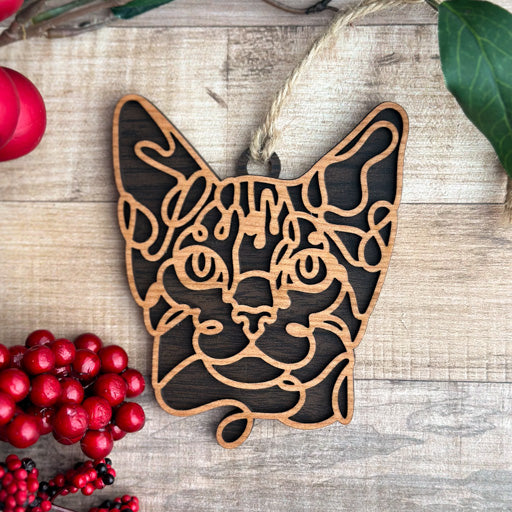 Egyptian Mau line art cat ornament laser cut from natural wood, minimalist feline silhouette design