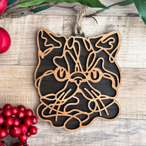 Exotic Shorthair line art cat ornament laser cut from natural wood, minimalist feline silhouette design