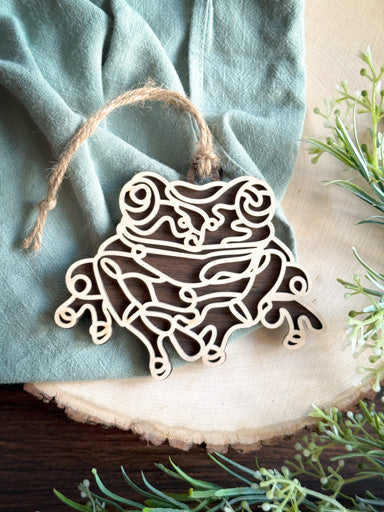  frog line art ornament laser cut from natural wood in continuous line style