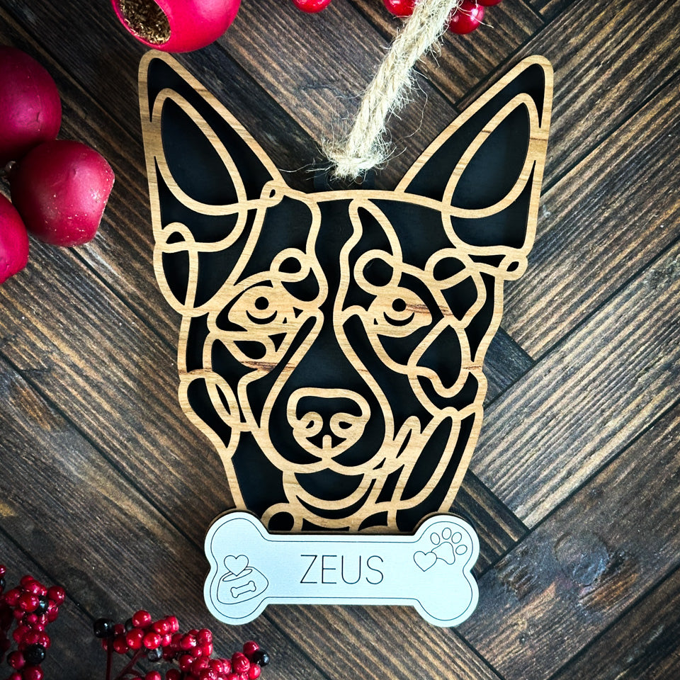 Heeler line art dog ornament laser cut from natural wood.