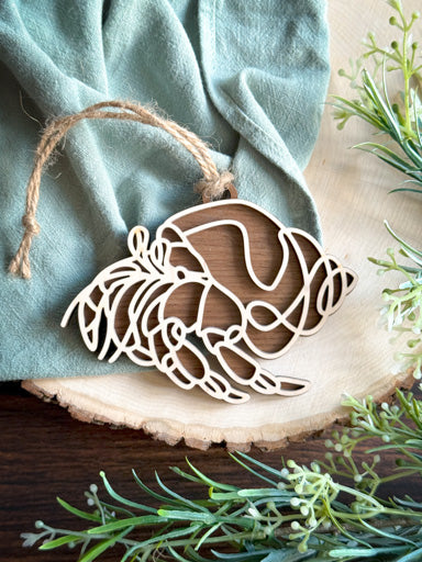 hermit crab line art ornament laser cut from natural wood in continuous line style