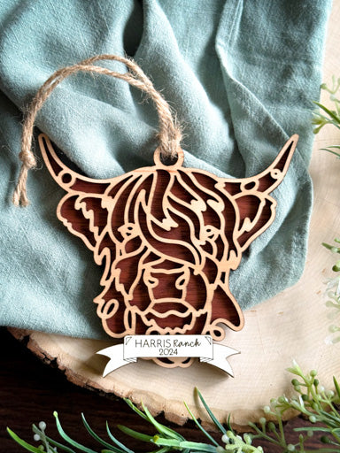 Highland cow line art ornament laser cut from natural wood in continuous line style