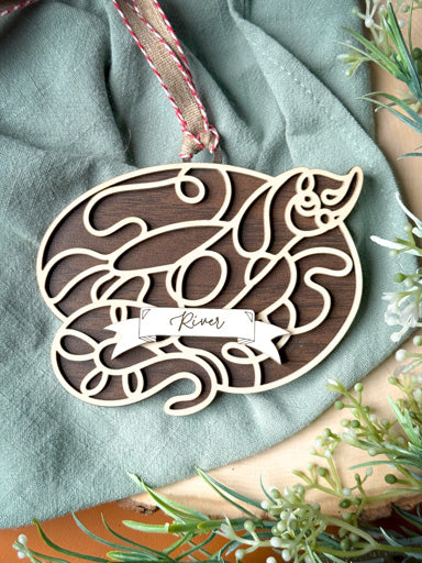 hognose snake line art ornament laser cut from natural wood in continuous line style