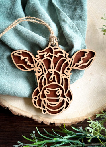 Jersey cow line art ornament laser cut from natural wood in continuous line style