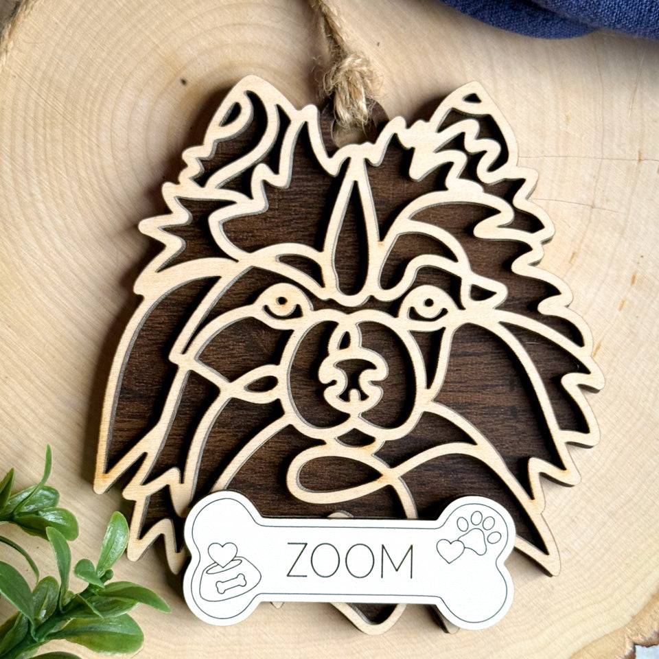 Keeshond line art dog ornament laser cut from natural wood.