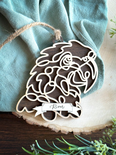 macaw line art ornament laser cut from natural wood in continuous line style