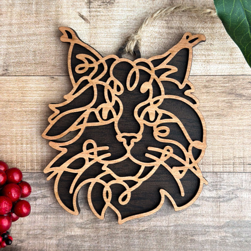 Maine Coon line art cat ornament laser cut from natural wood, minimalist feline silhouette design