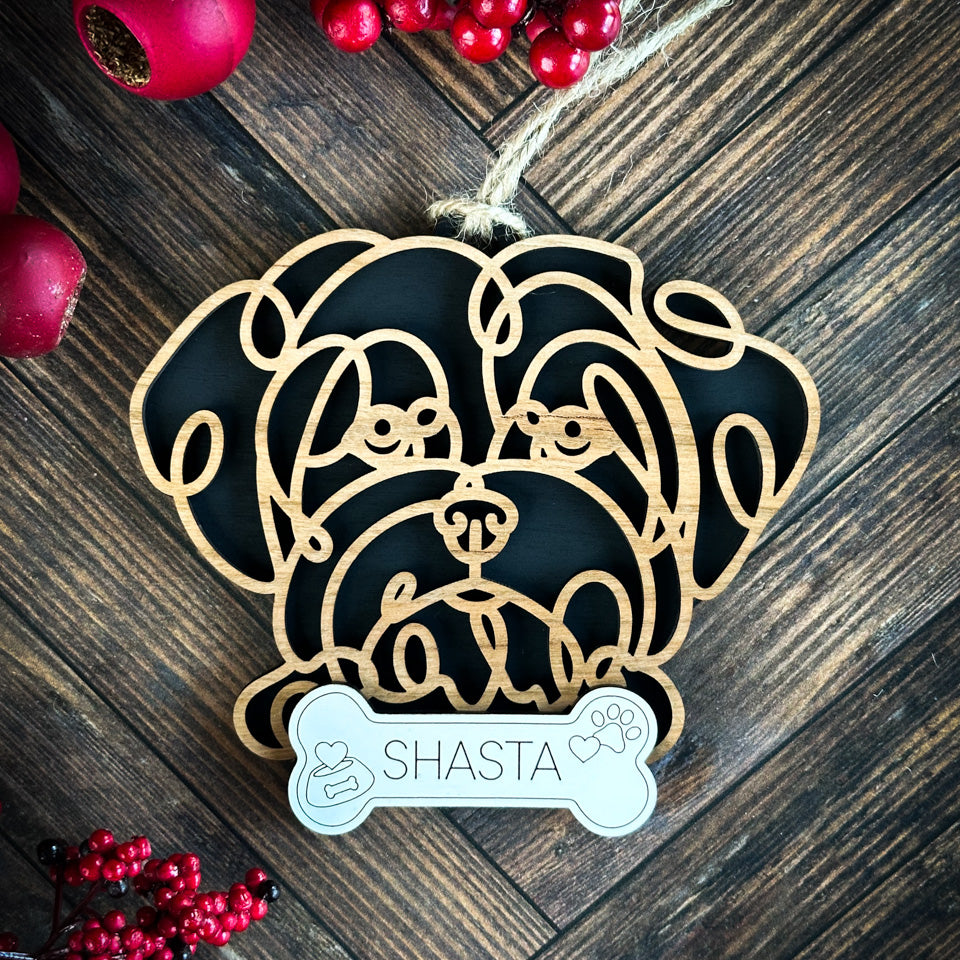 Maltese line art dog ornament laser cut from natural wood.