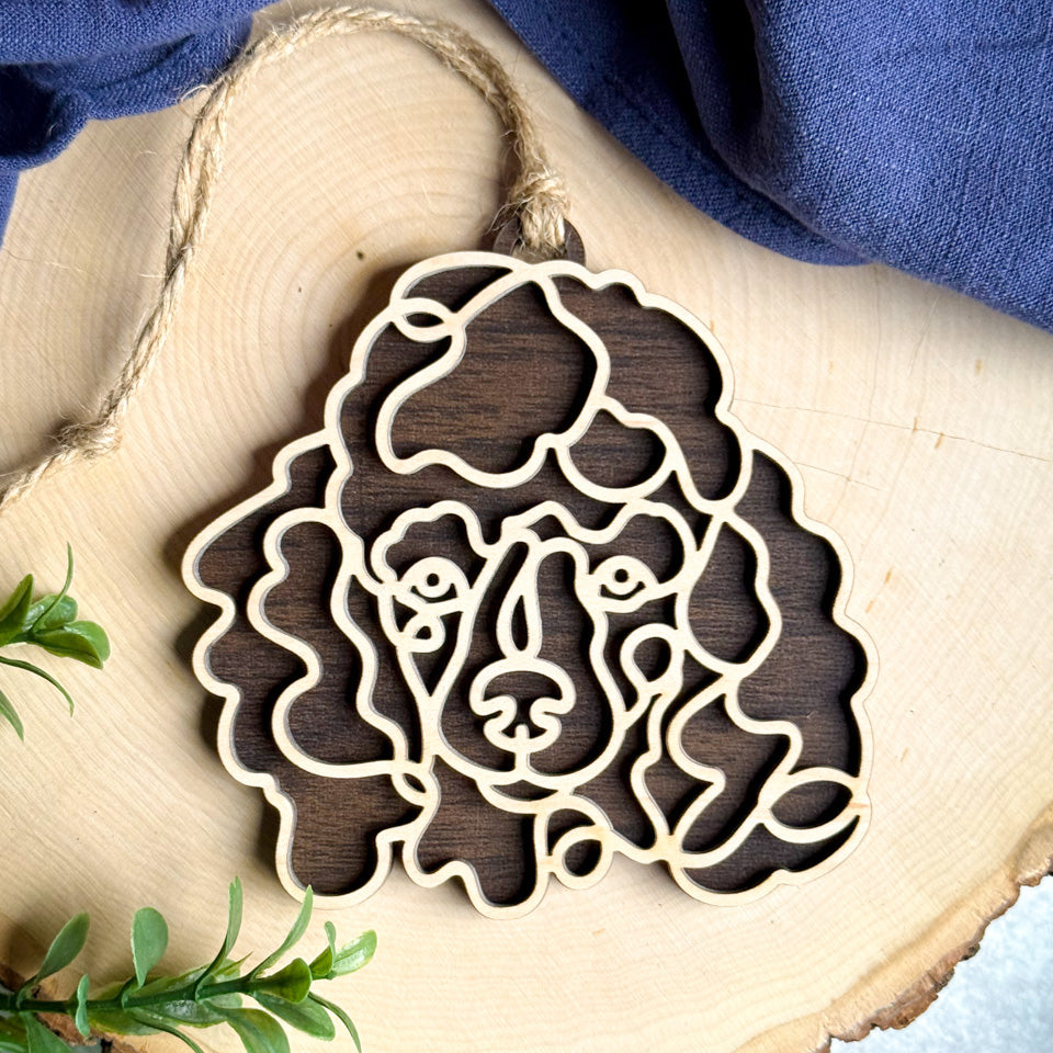 Miniature Poodle line art dog ornament laser cut from natural wood.