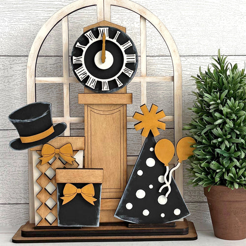 Decorative items including a clock, top hat, and decorative trees on a wooden stand celebrating the new year.