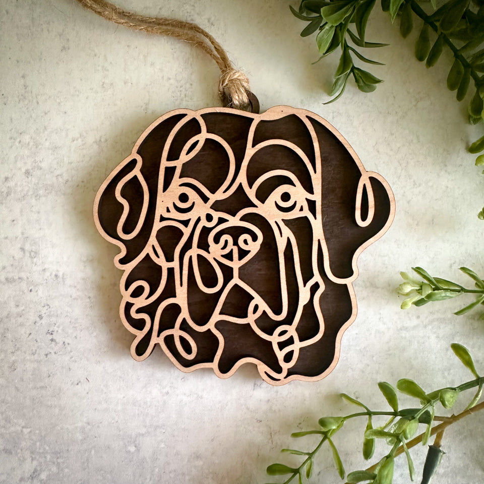 Newfoundland line art dog ornament laser cut from natural wood.