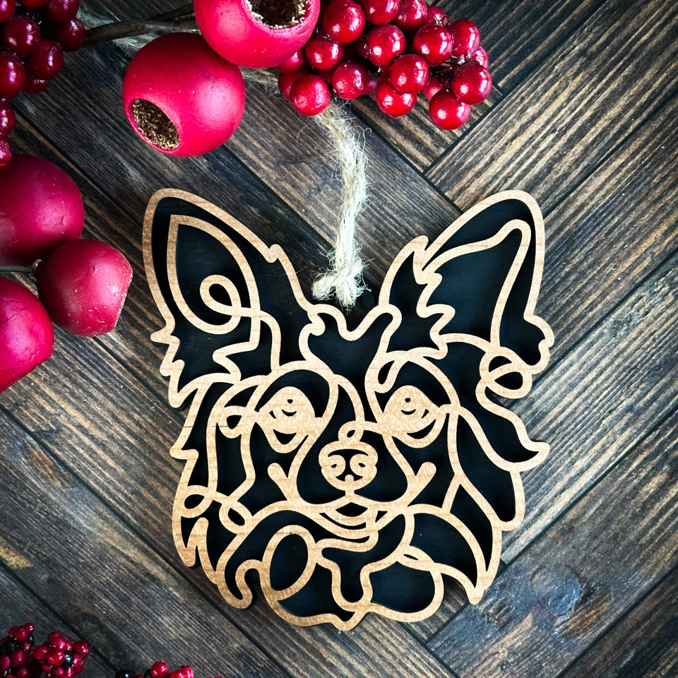 Papillon line art dog ornament laser cut from natural wood.
