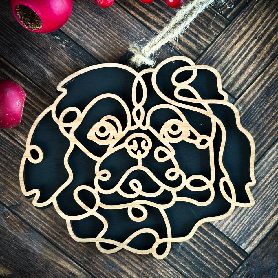 Pekingese line art dog ornament laser cut from natural wood.