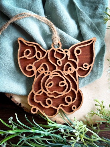 pig line art ornament laser cut from natural wood in continuous line style