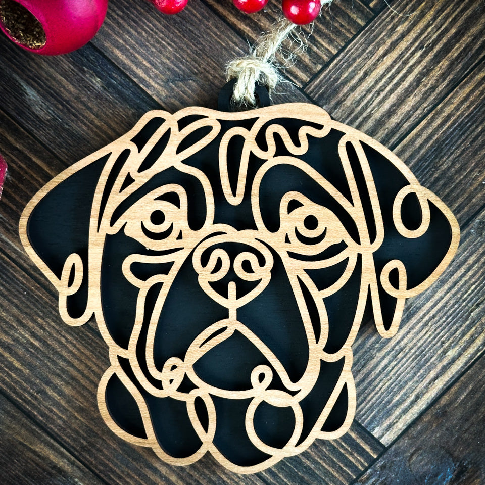 Puggle line art dog ornament laser cut from natural wood.