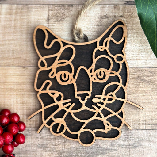 Russian Blue line art cat ornament laser cut from natural wood, minimalist feline silhouette design