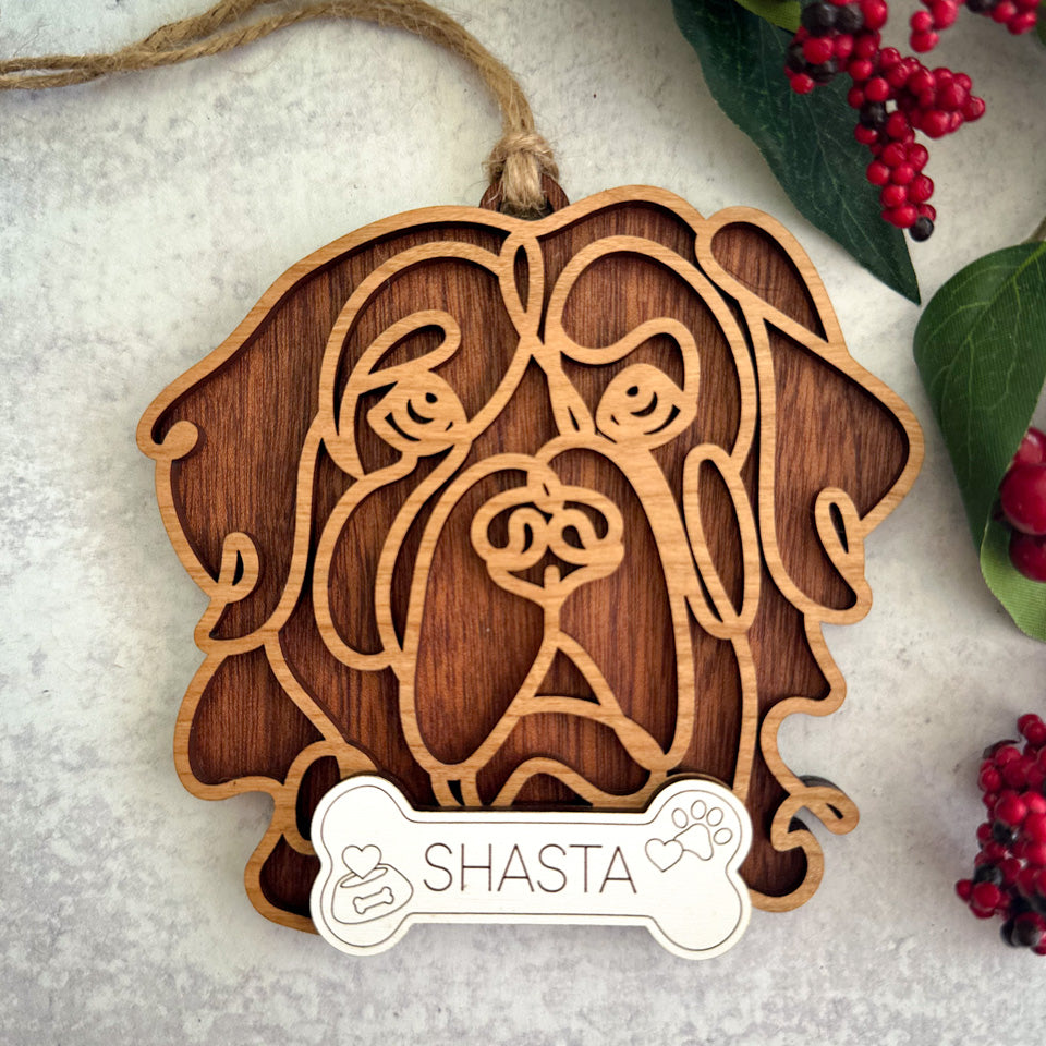 Saint Bernard line art dog ornament laser cut from natural wood.