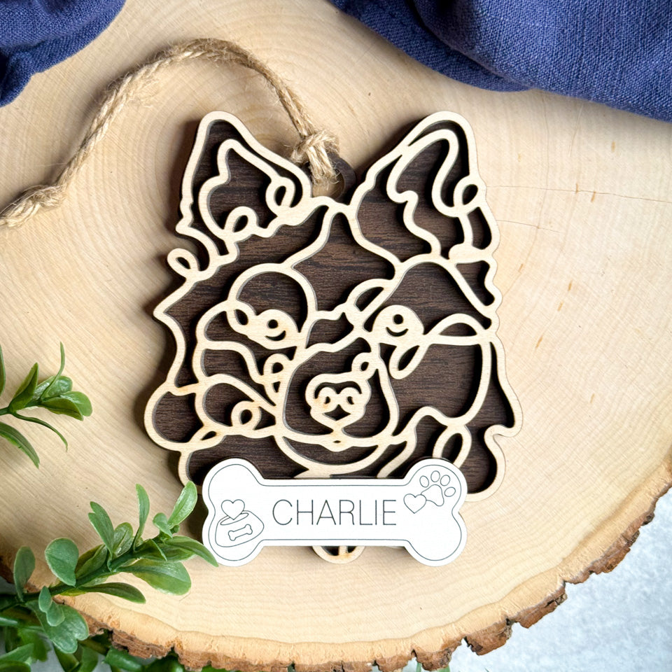 Schipperke line art dog ornament laser cut from natural wood.