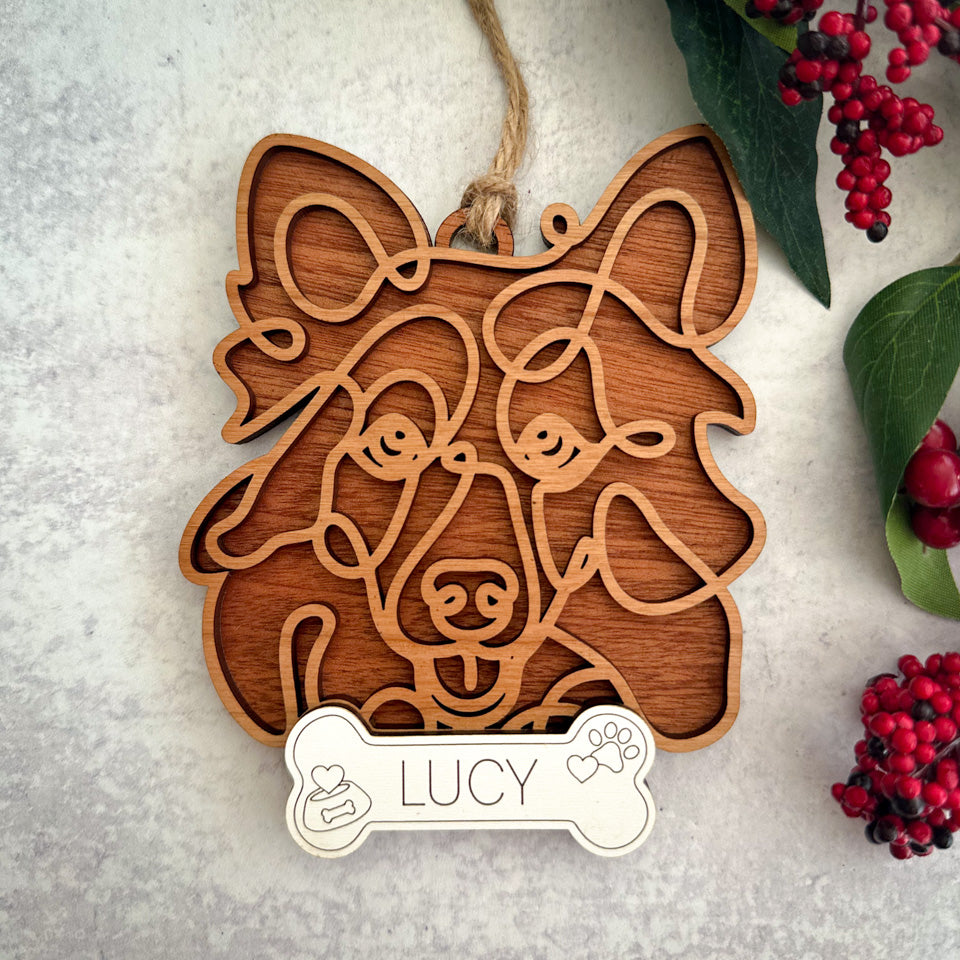 Sheltie line art dog ornament laser cut from natural wood.
