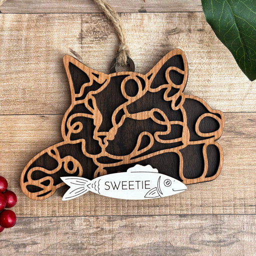 Sleeping Cat line art cat ornament laser cut from natural wood, minimalist feline silhouette design