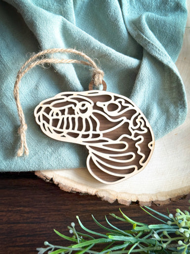 snake line art ornament laser cut from natural wood in continuous line style