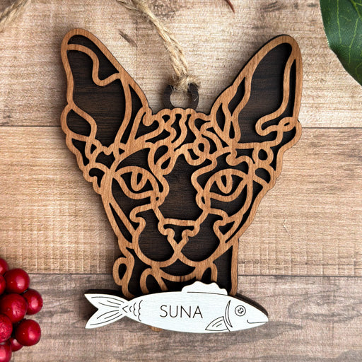Sphynx line art cat ornament laser cut from natural wood, minimalist feline silhouette design