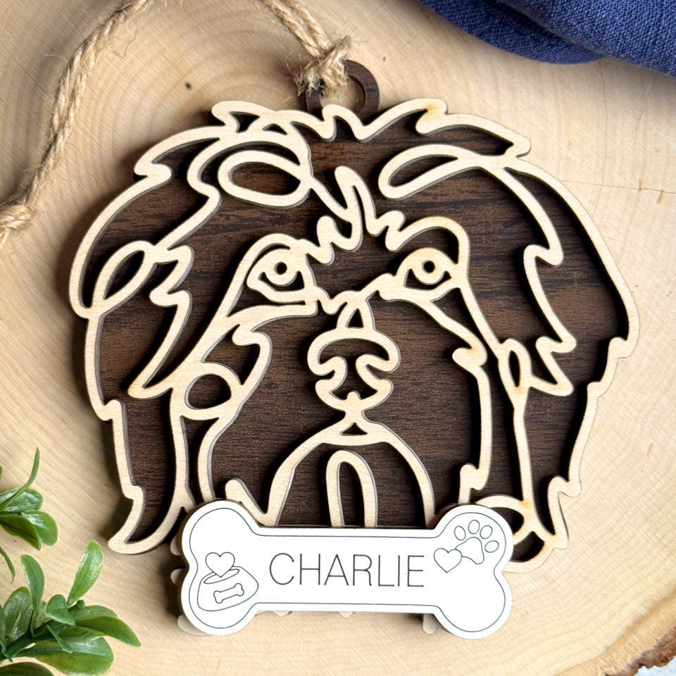 Tibetan Spaniel line art dog ornament laser cut from natural wood.