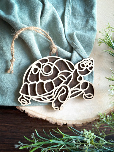 turtle line art ornament laser cut from natural wood in continuous line style