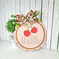 Decorative sign with cherries and 'hello' text on a wooden background