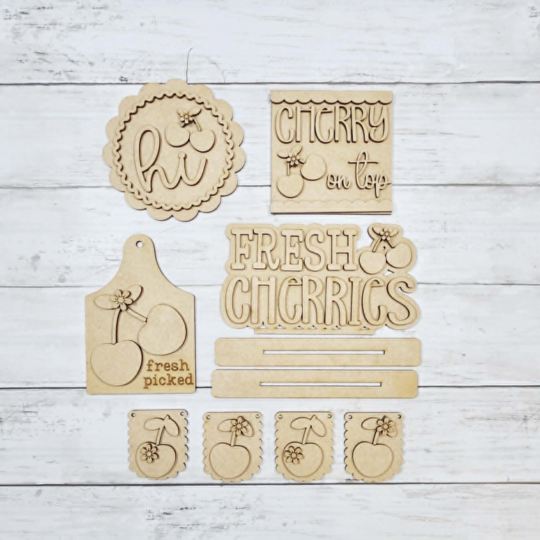 Set of wooden signs with various designs and text on a light wooden background