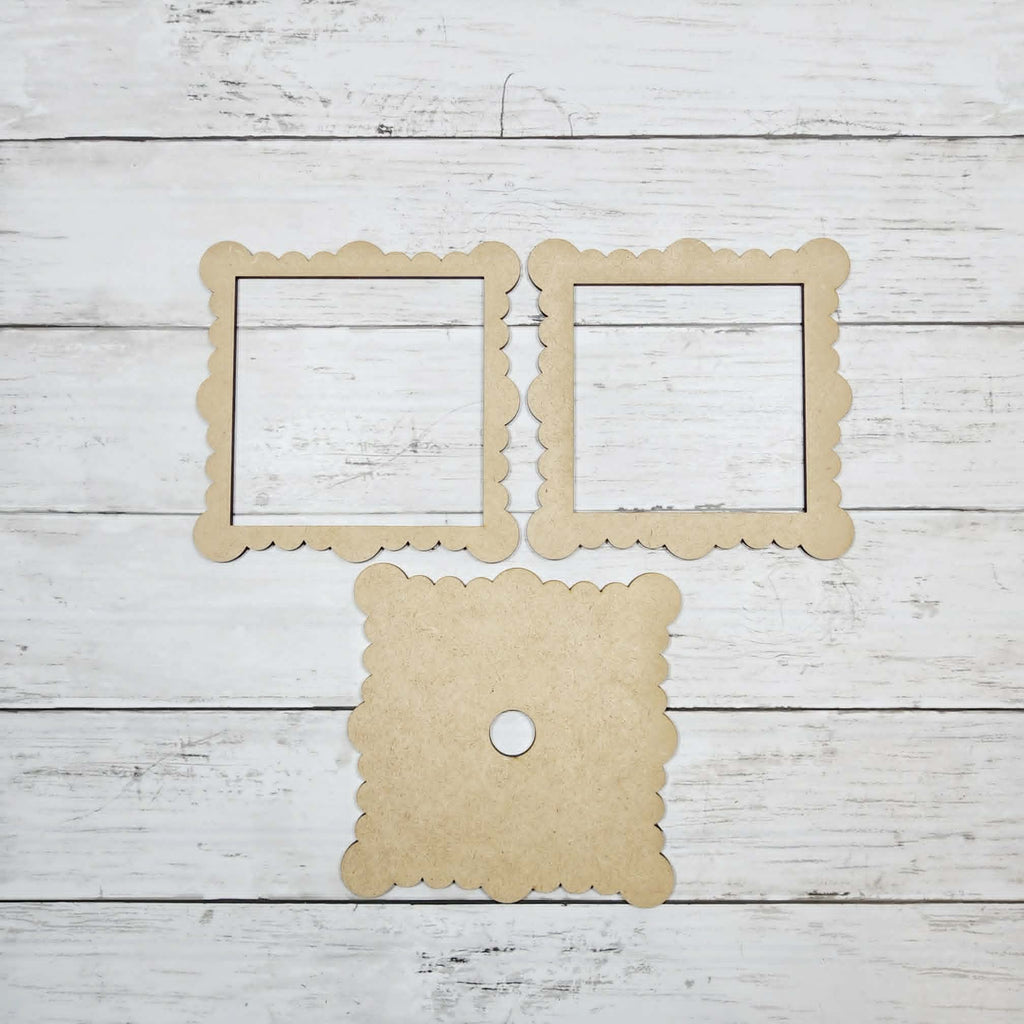 Three cardboard frames on a wooden surface