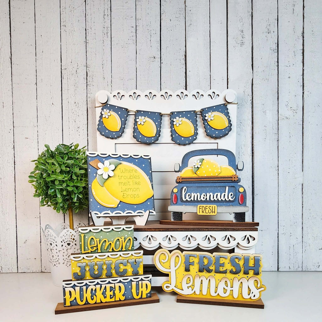 Decorative lemon-themed sign set with a wooden background